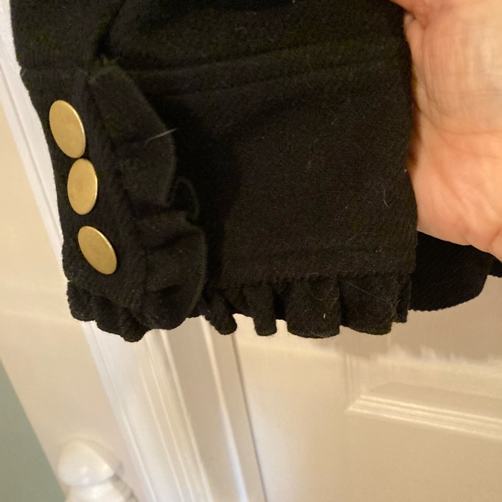 Stunning Black Wool over coat. Ruffled sleeve and pockets. NWT.